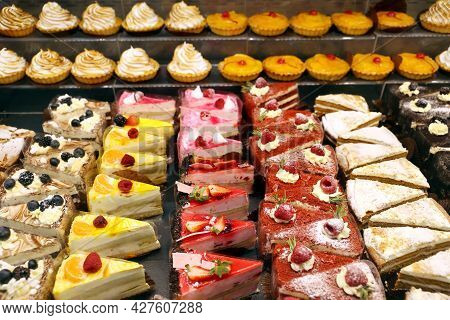 Different Cakes With Fresh Fruits And Berries In Store Window. Confectionery, Variation Of Desserts