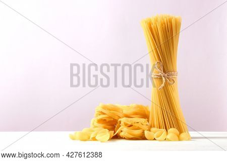 Different Types Of Pasta Close-up On A Colored Background