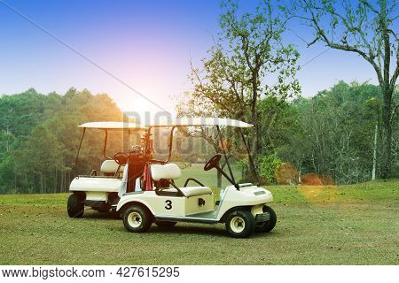Golfcar In Beautiful Golf Course In The Evening Golf Course With Sunshine In Thailand