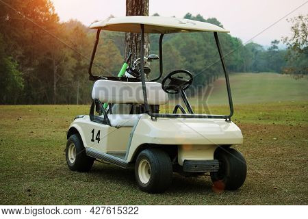 Golfcar In Beautiful Golf Course In The Evening Golf Course With Sunshine In Thailand