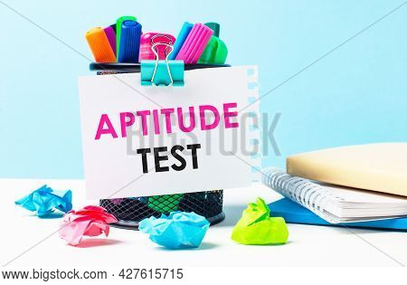 On A Blue Background - A Stand With Bright Markers, Notepads And Multi-colored Crumpled Pieces Of Pa