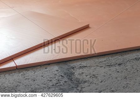 The Contractor Is Laying The Extruded Polystyrene Foam On The Floor. Underfloor Heating Device.