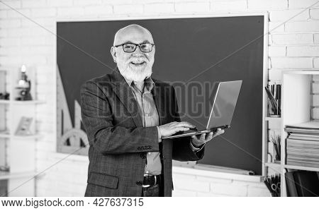 Online Service. Videoconferencing Keeps Homebound Students Connected. Senior Intelligent Man Teacher