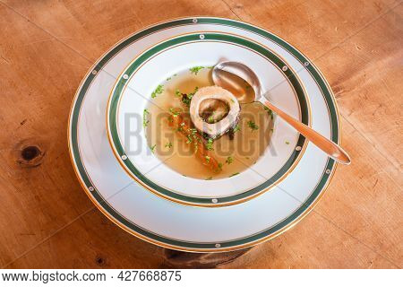 Beef Bouillon Soup With Marrow Bone, Carrot And Chives, An Austrian Style Broth