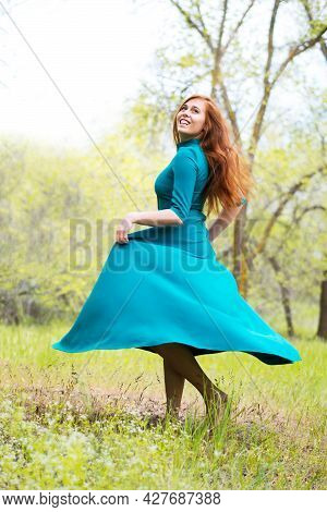 Beautiful Barefoot Woman Dance In Forest. Bootless Girl In Elegant Blue Dress Posing In Forest On Gr