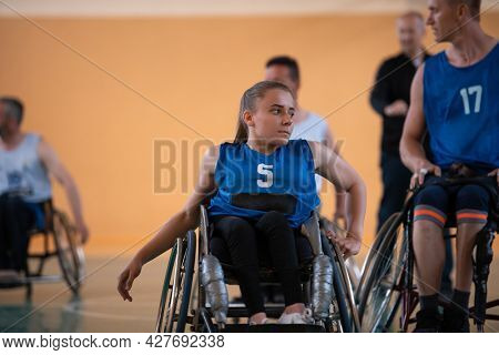 a young woman playing wheelchair basketball in a professional team. Gender equality, the concept of sports with disabilities. 