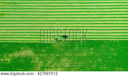 Above Top View On Tractor As Pulling Grass Cutting Machinery Over Field Of Clover, Cutting Alfalfa I
