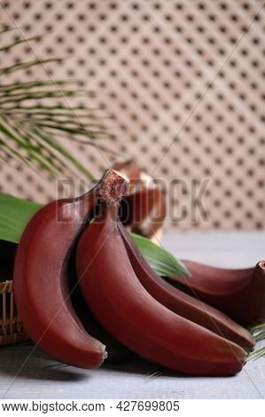 Tasty Red Baby Bananas On Grey Table, Space For Text