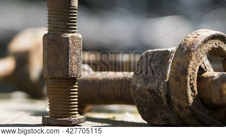 Old Rusty Bolt, Iron Rod With Screw Threads. Rusted Mechanical Components. Threaded Bolt And Nut. Di