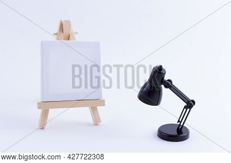 Wooden Easel Miniature With Blank White Square Canvas For Artists And Painters - Mockup. Mini Wooden