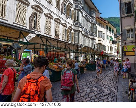 Bolzano, Italy, June 2021. At The Local Market, People Walk Among The Stalls Looking At The Goods. B
