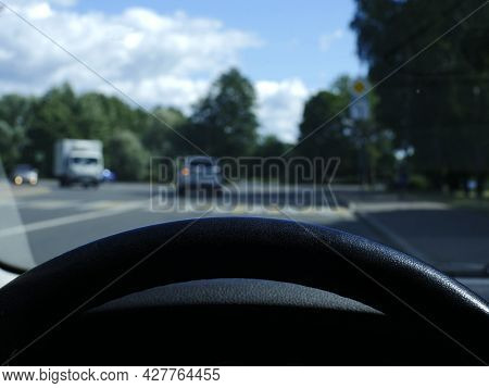 View From Behind The Steering Wheel Of A Car First-person View