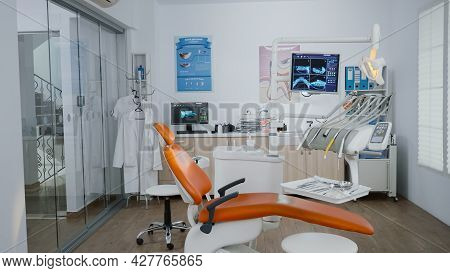 Empty Stomatology Orthodontist Office Room With Medical Drill And Dental Teeth Xray Images On Monito