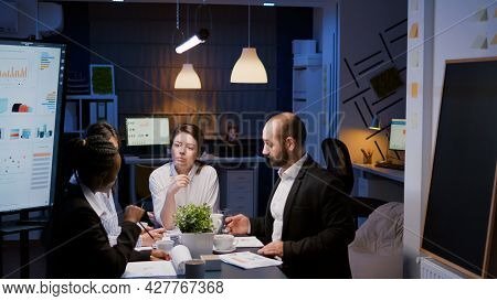 Businesswoman Leder Sitting At Desk Analyzing Marketing Presentation Discussing Financial Graps Pape