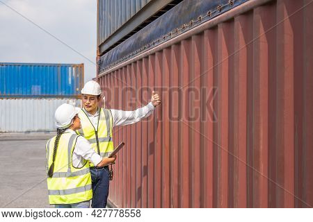 Asian Men And Women Freight  Supervisor Wearing Safety Vest And Hat While Inspect Condition Of All C