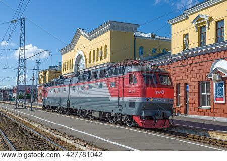 Orel, Russia - July 06, 2021: Czech Passenger Electric Locomotive Chs7 In Front Of The Railway Stati