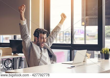 I Finished The Challenge! A Very Happy Businessman Is Utilizing A Laptop Computer At The Office. The