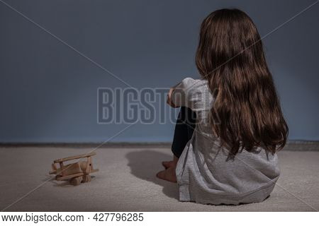 Lonely Sad Girl At Home. Saddened Alarmed Child Alone At Home.