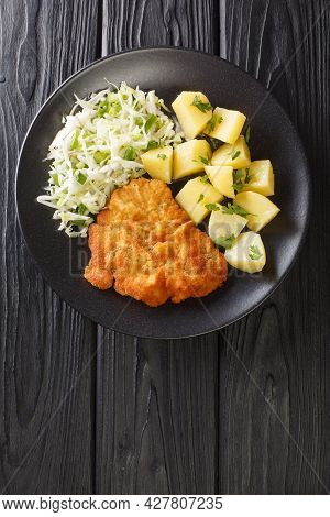 Kotlet Schabowy Polish Breaded Pork Chop With Boiled Potatoes And Cabbage Salad Close-up In A Plate 
