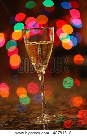 Yeni Yılınız Kutlu Olsun!!! Noel ışıkları arka planda kabarcıklanma şampanya bir kadeh.