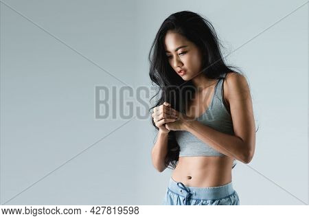 Asian Woman With Sexy Shapely Forms Posing In Trendy Look. Portrait Of A Brunette Model With Bright 