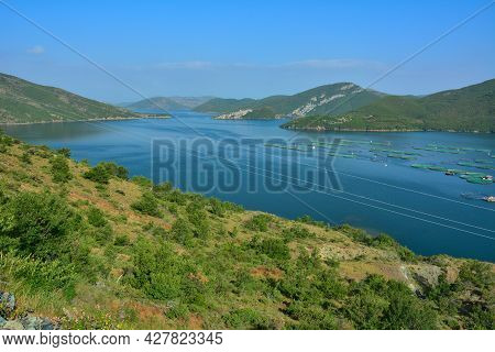 Blue Waters Of Koman Lake In Northern Albania. Reservoir Built On Drin River, Surrounded By Forested