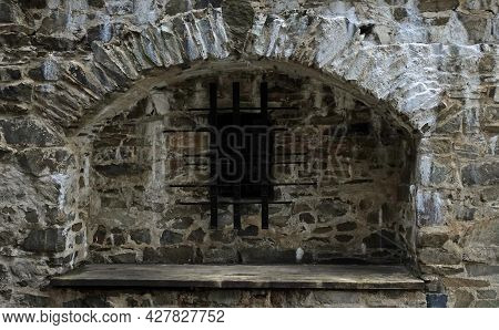 Barred Window In The Ruins Of The Stone Masonry Of The Castle Helfstyn