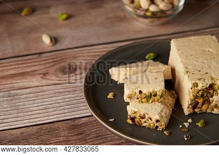 Organic Halva With Pistachios On A Wooden Surface. Traditional Middle Eastern Sweets. Jewish, Turkis