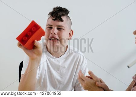 Disabled Teenage Child Build From Blocks Boy With Cerebral Palsy Doing Activities For Children With 