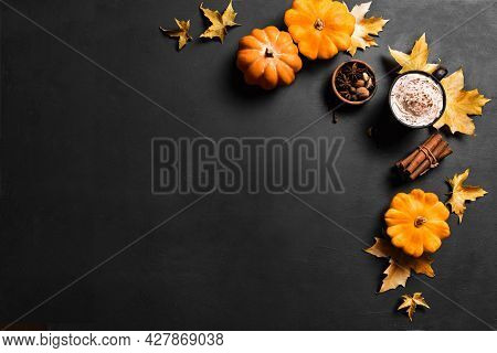 Autumn Composition With Pumpkins, Maple Leaves And Pumpkin Spice Latte Coffee On Black, Top View, Co