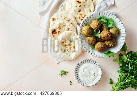 Homemade Falafel, Freshly Baked Pitas, Refreshing Sauce With Herbs. Middle Eastern Cuisine. Top View