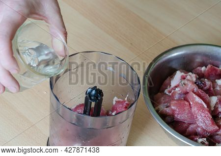 Step By Step Preparation Of Homemade Chopped Ham. Step 5: The Hand Pours Water From The Glass Into T