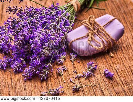Lavender Flowers Extract Spa Soap And Bunch Of Lavender Floawers On Wooden Board