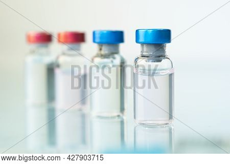 Medicine In Bottles With Red And Blue Capsule. On A Blue Background. Copy Space.