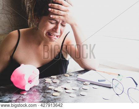 A Girl With A Piggy Bank, She Has No Money, She Looks At Pennies And Cries. Counts Expenses And Util