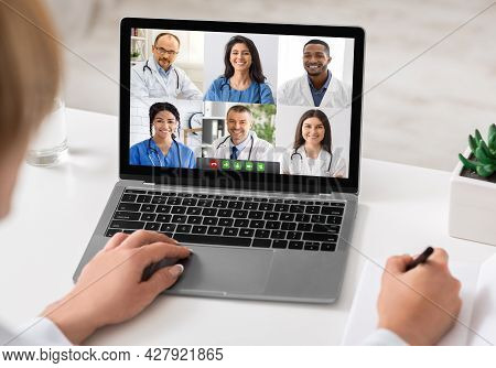 Female Doctor Having Video Call With Team Of Therapists Indoor