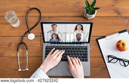 Above View Of Female Doctor Video Calling Diverse Colleagues Indoor