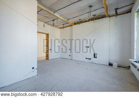 Empty Unfurnished Room With Minimal Preparatory Repairs. Interior With White Walls And Drywall