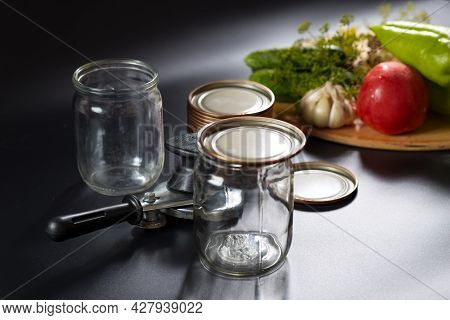 Vegetables For Canning On Background And Canning Tool With Glass Jars On A Front, On Black Backgroun
