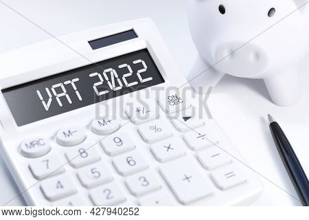 Text Vat 2022 - Value - Added Tax On Calculator, Laptop, Chatrs, Graphs. Business Flat Lay.