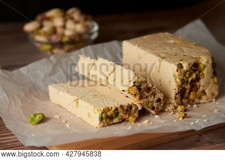 Organic Halva With Pistachios On A Wooden Surface. Traditional Middle Eastern Sweets. Jewish, turkis