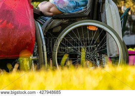 Low Angle Photo Of Two People In Wheelchairs Having Fellowship Around Table During Sunset. Happy Pho