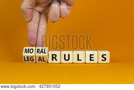 Legal Or Moral Rules Symbol. Businessman Turns Wooden Cubes And Changes Words 'legal Rules' To 'mora