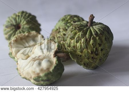 Cherimoya Is A Green, Cone-shaped Fruit With Leathery Skin And Creamy, Sweet Flesh. It Is Also Known