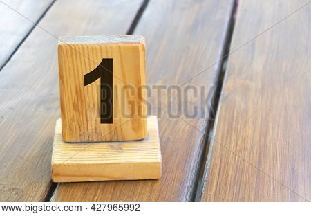Wooden Priority Number 1 On A Plank Tab.