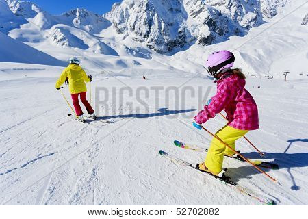Skiing, winter, ski lesson - skiers on ski run