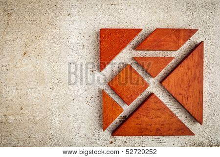 seven tangram wooden pieces, a traditional Chinese puzzle game, rough white painted barn wood background