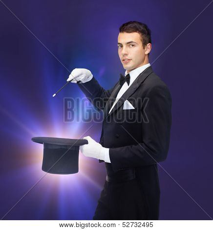 performance, circus, show concept - magician in top hat with magic wand showing trick