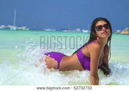 The beautiful girl in bikini on a beach