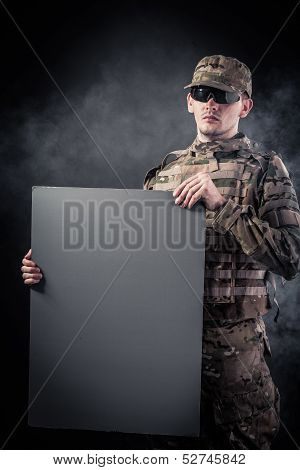 Modern Soldier Is Holding A Poster